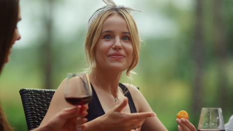 emotional woman telling story on backyard. blond woman making hand gestures