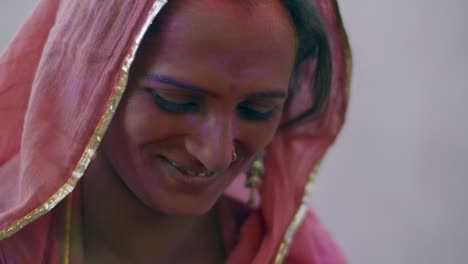 indian women close-up of face smeared with bright holi colors