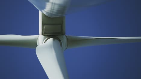 afternoon underneath perspective with closer view footage from a wind turbine machine and its rotating blades