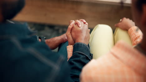 couple holding hands in a close and supportive relationship