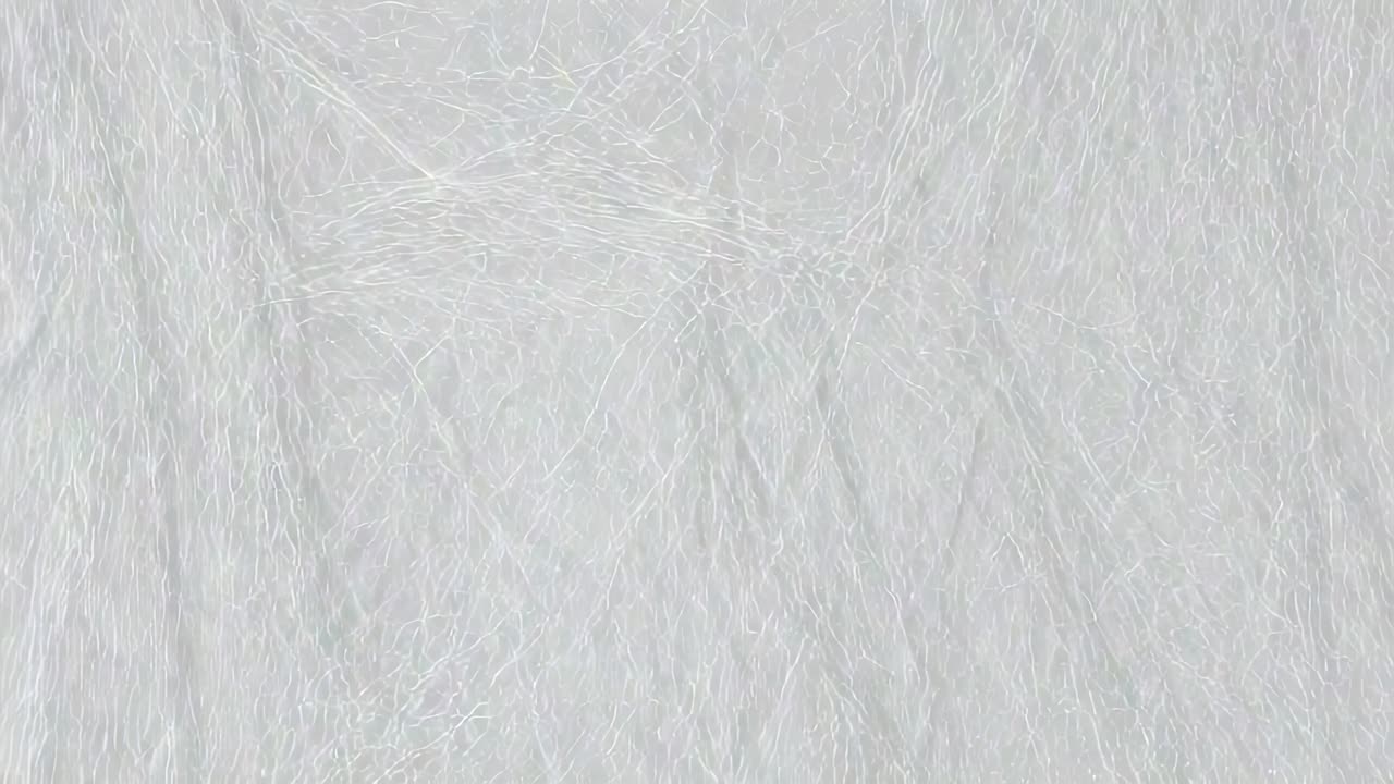 Looping footage showing fibrous texture covering frame on screen, emphasizing intersecting threads