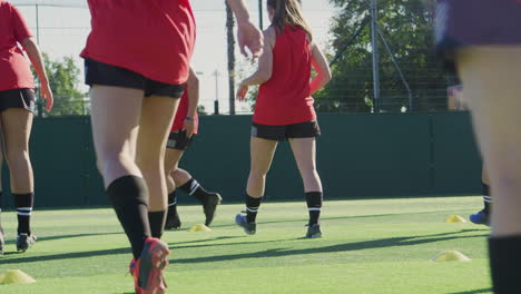 Close-Up-Of-Female-Soccer-Team-Warming-Up-During-Training-Before-Match