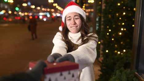 woman exchanging gifts outdoors at night