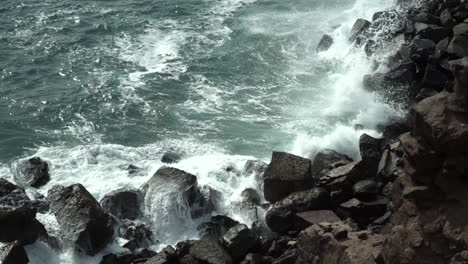 waves crashing on rocks in chorrillos, lima, peru slow motion