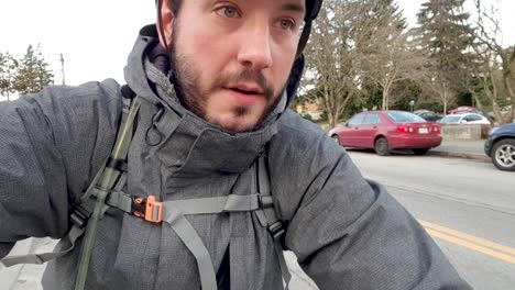 man on bike ride selfie while cruising through a busy road in the city