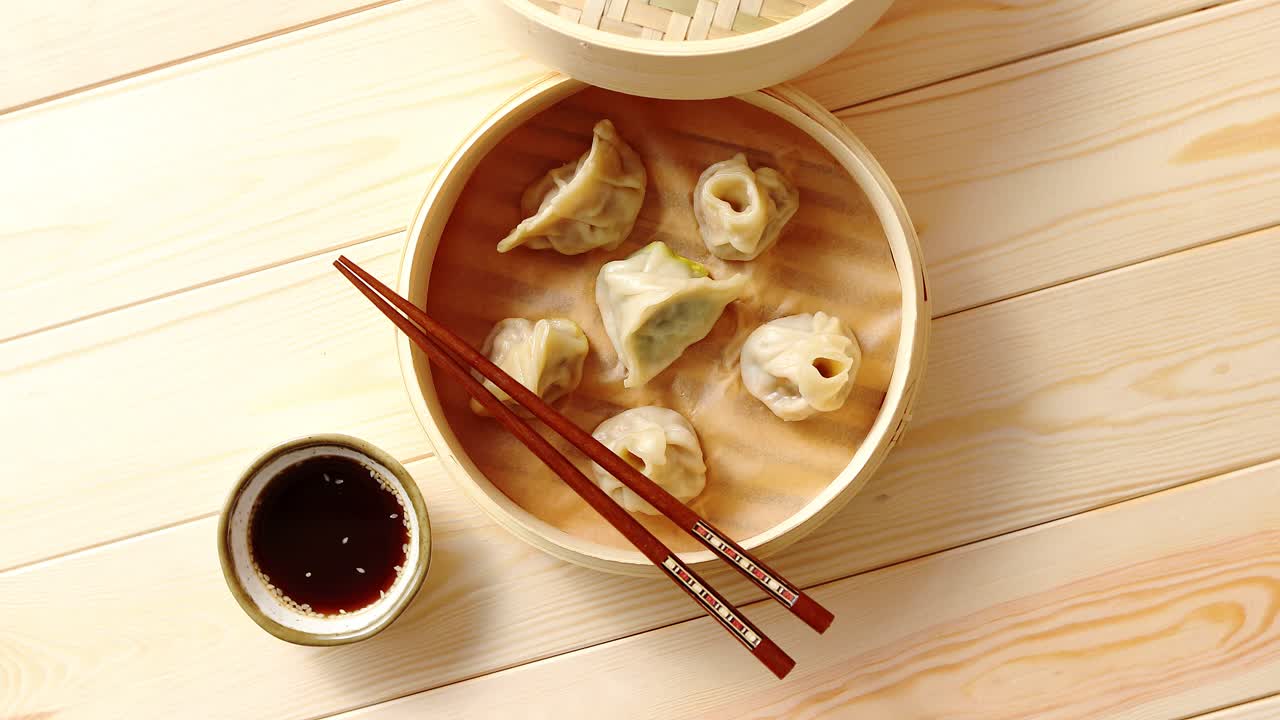 Traditional chinese dumplings served in the wooden bamboo steamer