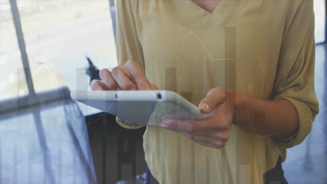 using tablet, person interacting with financial data animation over bar graphs