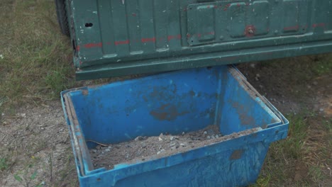 Sweeping-gravel-and-sand-from-pickup-truck-bed-into-bucket