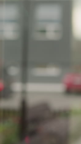 hand of elegant woman opening glass door of office building showing reflection of cars on street. elegant employee goes to work closeup slow motion