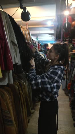 woman shopping for vintage jackets in a clothing store