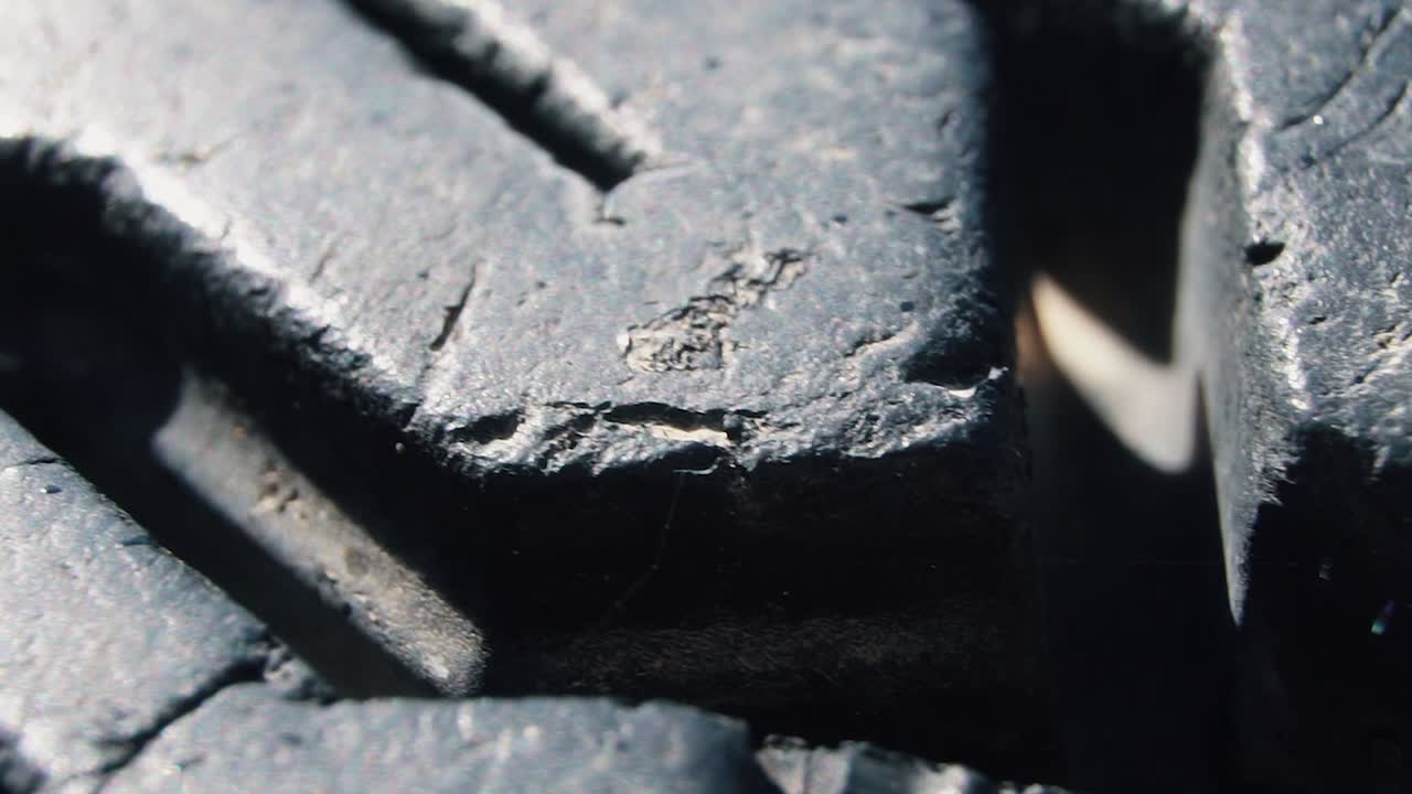 Close-up tyre of the car. Car rubber wheel in macro 4k video. High quality 4k footage