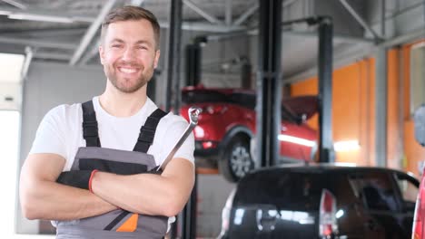professional auto mechanic smiling in a car repair shop