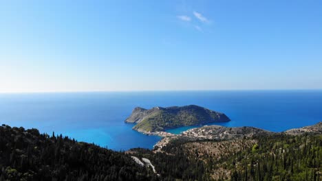 aerial view at asos village, peninsula, and turquoise blue ionian sea water during daytime - drone shot