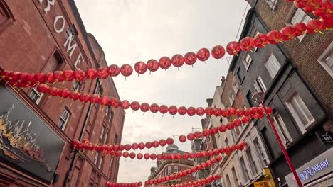 red lanterns strung across alley in london