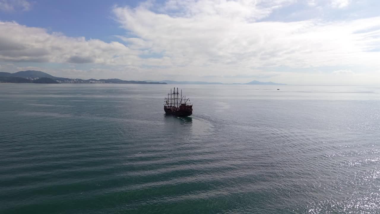 Drone view of pirate ship attraction cruising along Balneario Camboriu coastline Brazil