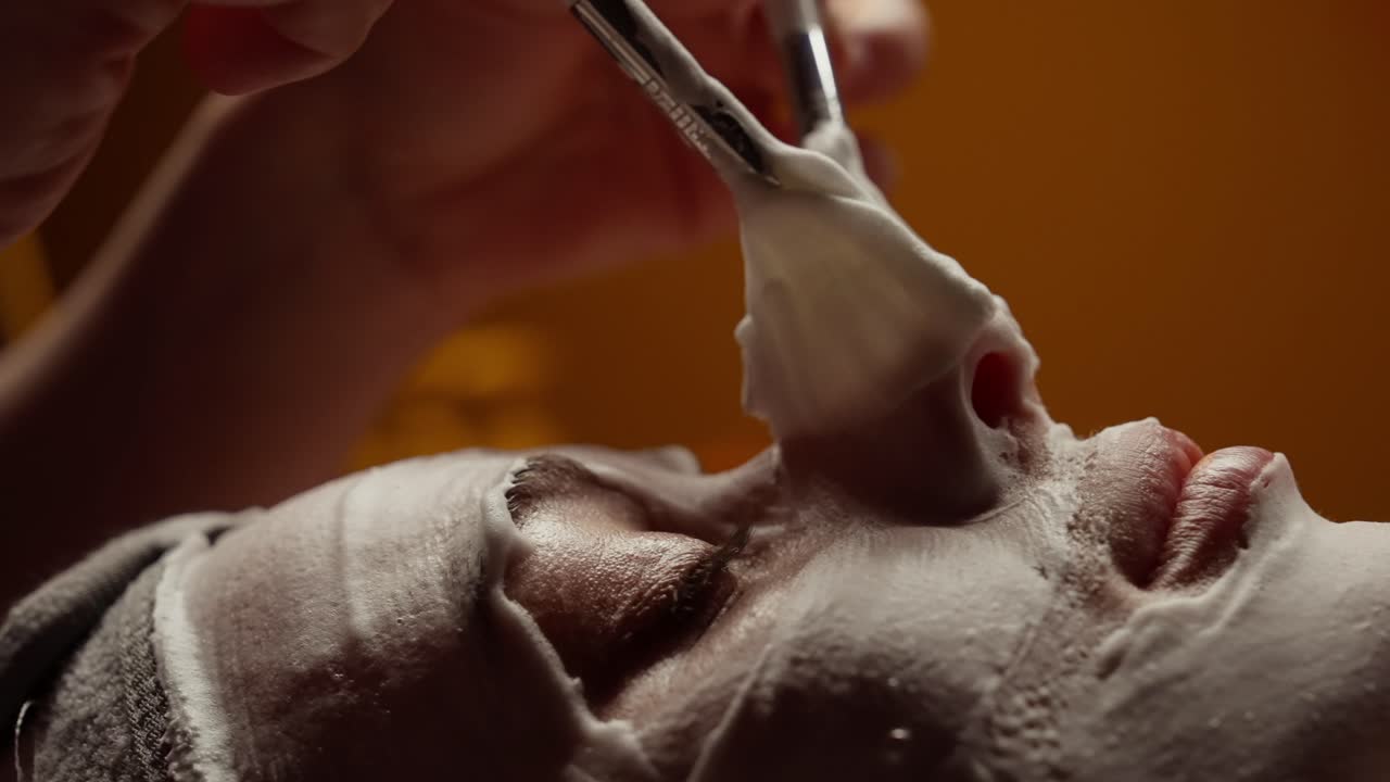 Close-up Wanita Menerima Perawatan Masker Wajah dengan Kuas