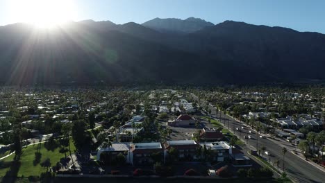 sunset in palm springs california above palm canyon drive with cars driving down the highway