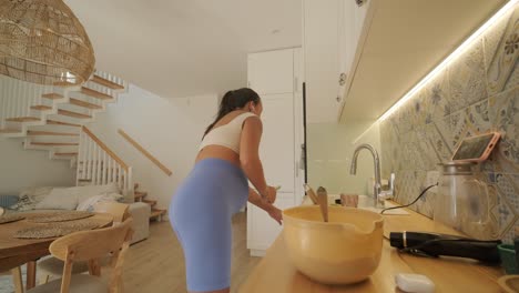 a pregnant woman enjoying her daily routine at home, relaxing in the living room and eating in the kitchen. the scene highlights comfort, maternity, and moments of self-care in a cozy setting