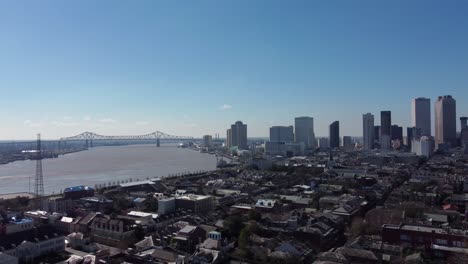 aerial: new orleans skyline and bridge crossing the mississippi river