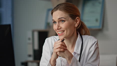 smiling practitioner communicating web conference. closeup doctor consulting