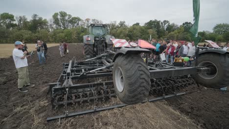 demonstration of agricultural machinery at an exhibition. tractors operate in the field, showcasing their capabilities and performance in action