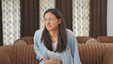 indian woman suffering from stomach ache