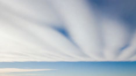 streaked clouds across a blue sky