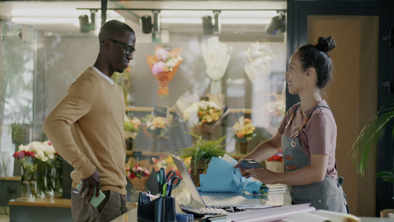Customer Receiving Flowers at a Florist Shop