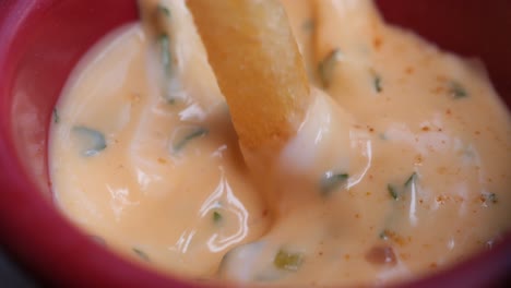 close-up of a creamy chili sauce in a red bowl