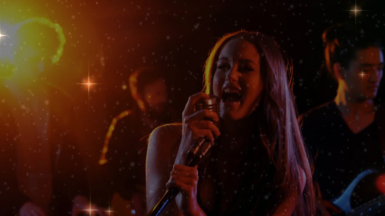Lead female vocalist rising as camera tilts, with retro mic, singing music, band behind, sparkles
