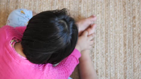 young child sitting on the floor