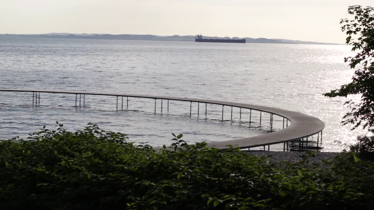 Infinite bridge in Aarhus, Denmark an early morning during sunrise. Paning right.
