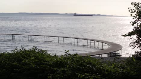 infinite bridge in aarhus, denmark an early morning during sunrise. paning right.