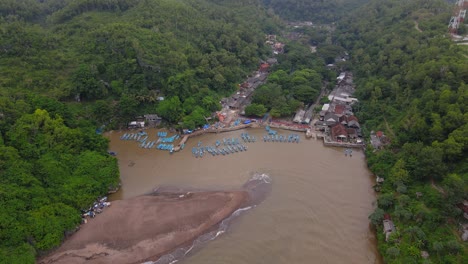 Aerial-view-of-fisherman-harbour-on-the-bay-that-surrounded-by-forest-and-hill