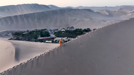 woman walking by sand dune