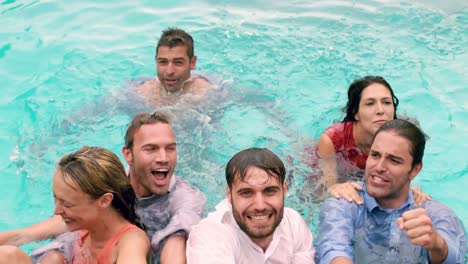 happy friends jumping in the swimming pool