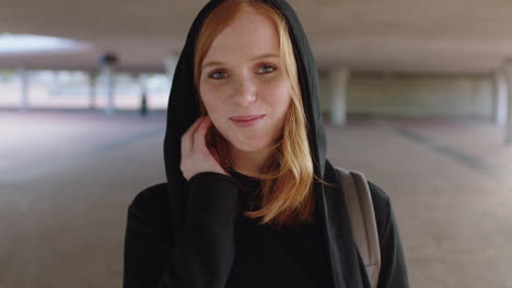portrait of young redhead woman smiling shy wearing hoodie