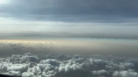 cockpit lateral view of some clouds during sunrise, with a dusty sky