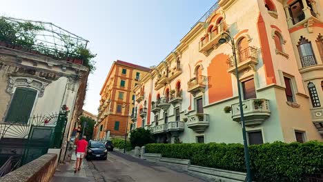 a person walks along a picturesque naples street