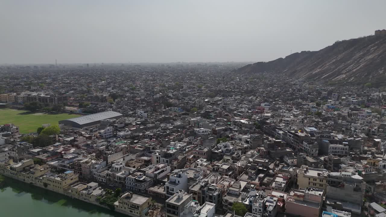 High-angle view of a historic fort perched atop a steep, rocky hill.