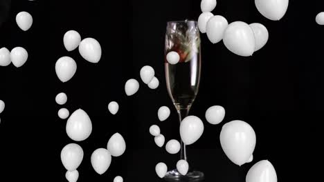 animation of white balloons over glass of champagne on black background