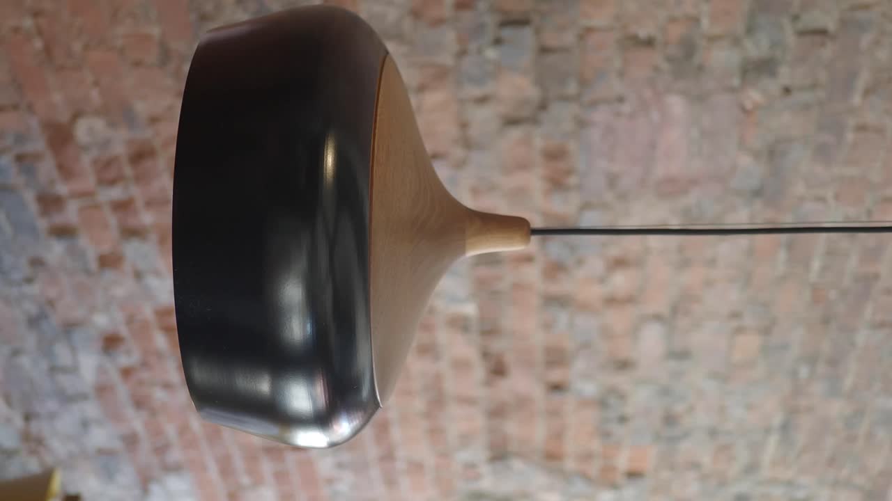 Modern Pendant Lamp against a Brick Wall Background