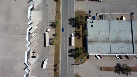 Aerial-Shot-Following-Semi-Truck-in-Industrial-Area-in-Summertime