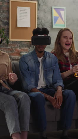 black man with vr headset and positive friends watch basketball game in apartment slow motion. digital technology of augmented reality for sports fans