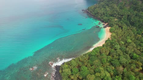 rising view with camera going down ,where we can appreciate the magnificent banana beach and the coast of ilha do principe (prince island) sao tome,africa