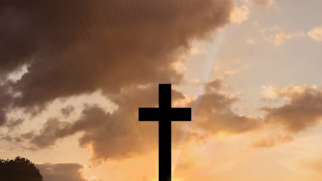 animation of christian cross over sun rays on orange sky with clouds