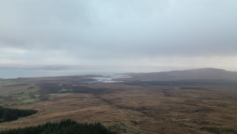 Circular-Aerial-Reveals-View-of-Field-With-Distant-Scottish-Lochs