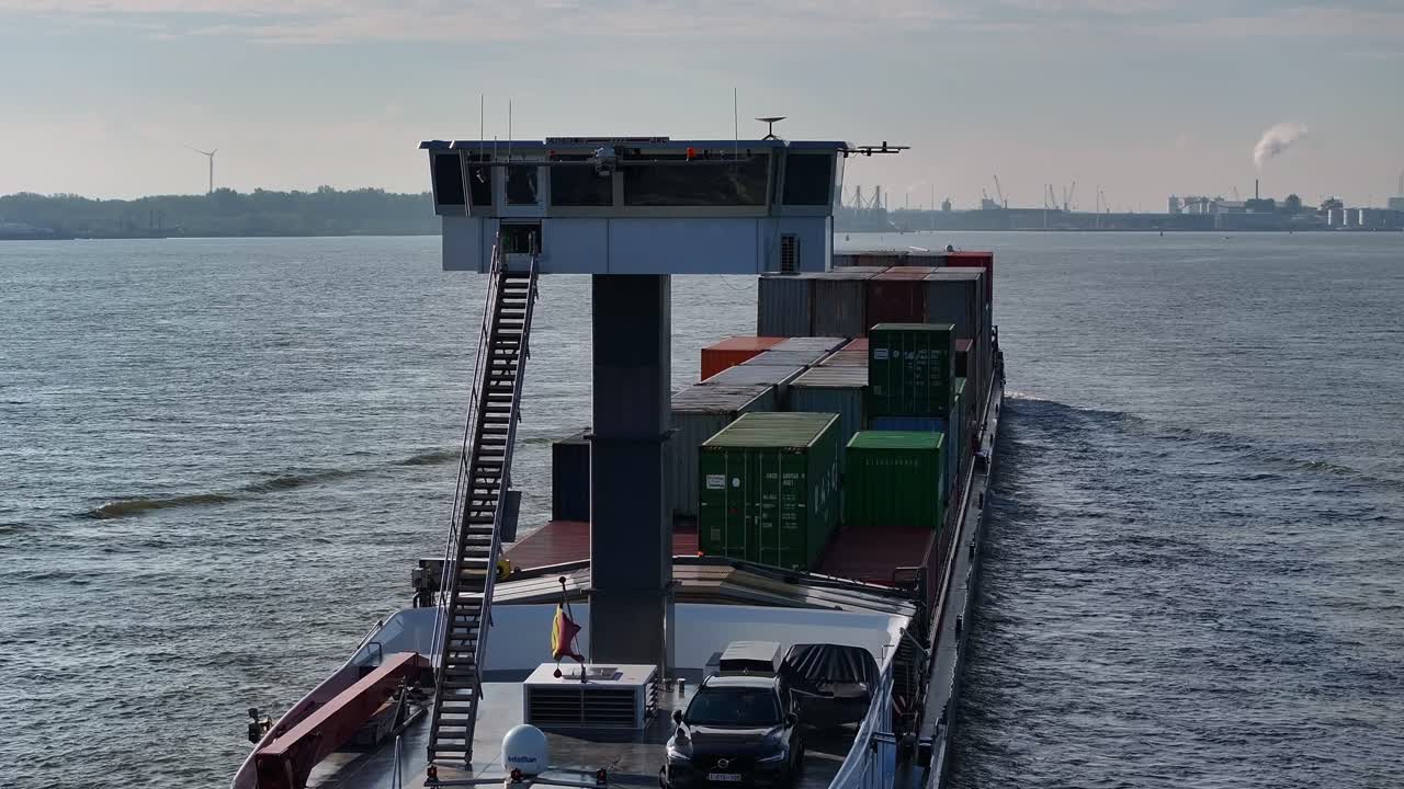 Ship sailing past with container boxes, industrial scene, calm river background