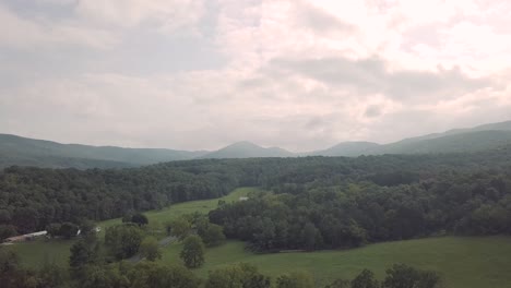 drone flying forward over trees and forest in the smoky mountains in eastern tennessee during a cloudy day with some sun