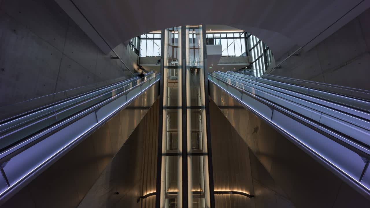 Upper part of the underground station for Bybanen at Haukeland hospital in Bergen, Norway. People moving up and down the escalators and lifts.